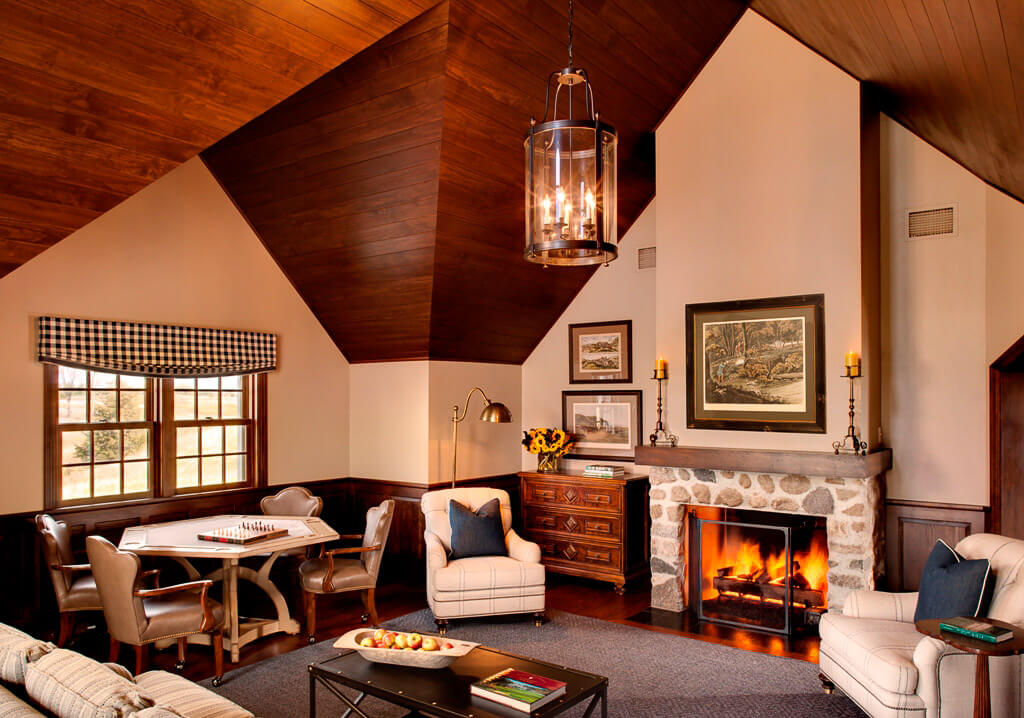 entertainment-room-interior-design-inspo-vaulted-wooden-celing-stone-fireplace-card-table-milwaukee-wisconsin